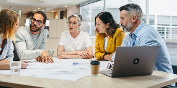 An enterprise architect having a meeting with colleagues regarding business objectives.