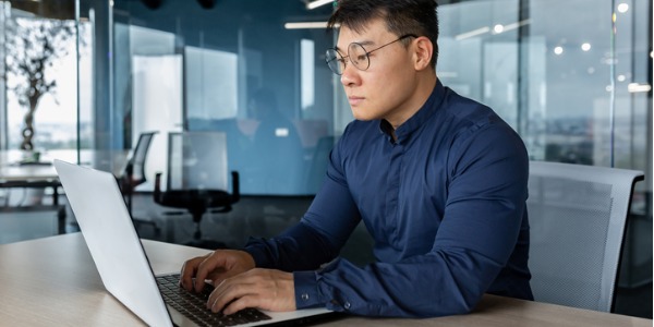 A database architect working on his computer.