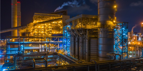 The outside of a power plant at night.