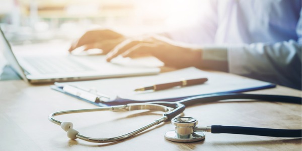 A nurse researcher writing a report.