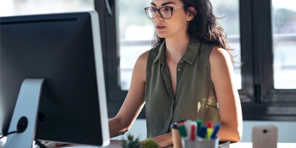 A researcher analyzing data on her computer.