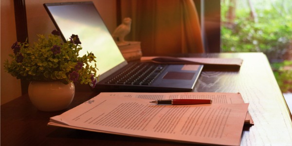 A playwright's desk, computer, and script.