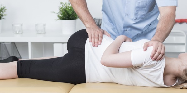 A sports chiropractor giving a patient an adjustment.