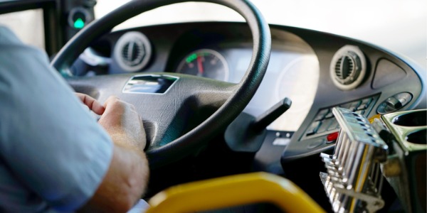 A bus driver driving a bus.
