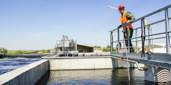 A water resources engineer looking over a water reservoir.