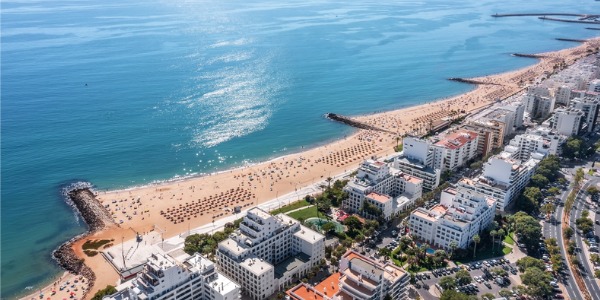 An aerial shot of a long seashore with many breakwalls designed by coastal engineers.