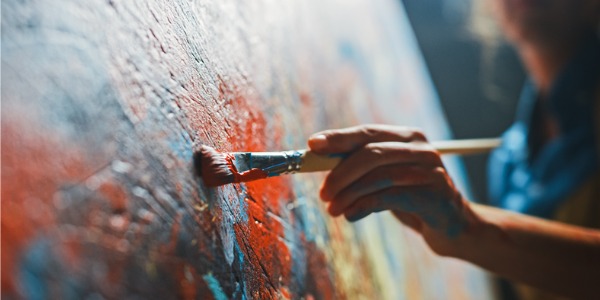 A painter applying paint to a canvas.