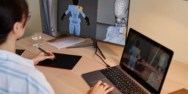 A technical artist creating 3D characters on her computer.