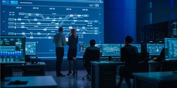 A command and control center specialist talking to a colleague.