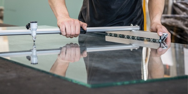 A glazier cutting glass.
