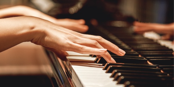 A piano accompanist playing the piano.