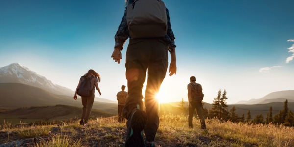 A park naturalist taking a group of people on a hike.