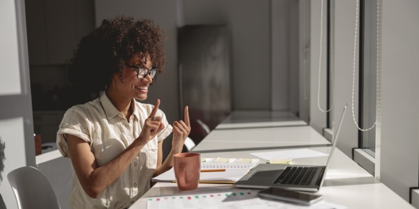 An American Sign Language interpreter signing for a deaf individual online.