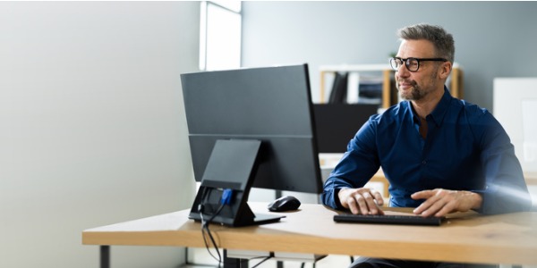 An information security director working at his desk.