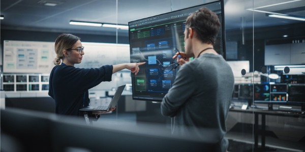 An information security manager talking with a colleague.