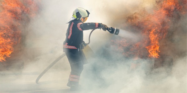 An airport firefighter fighting a fire.
