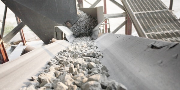 Stone being fed onto a conveyor belt.