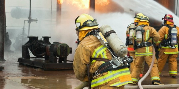Firefighters fighting an industrial fire.