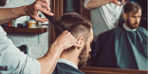 A barber cutting his client's hair.