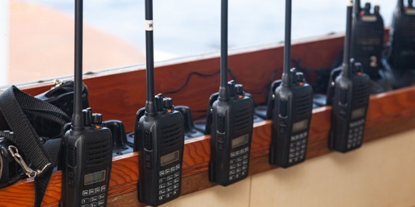 A row of walkie-talkies, serviced by radio mechanics.