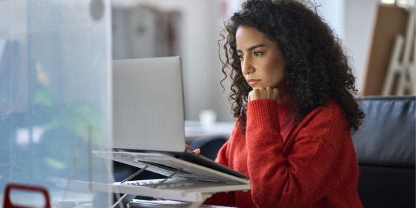 A computer and information research scientist working on her computer.