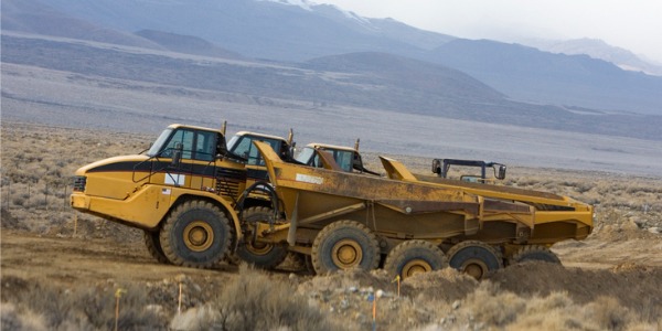 Three mine shuttle cars above ground.