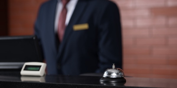 A lodging manager working at the front desk.