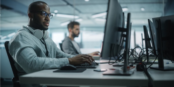 Two computer scientists working on their computers.