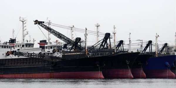 Cargo ships lined up at the port, the workplace of merchant mariners.
