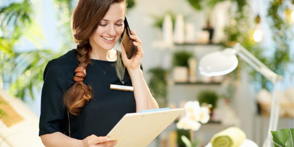 A spa manager talking on the phone.