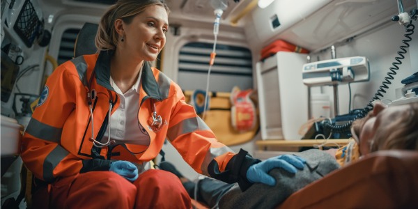 A paramedic talking to a patient.