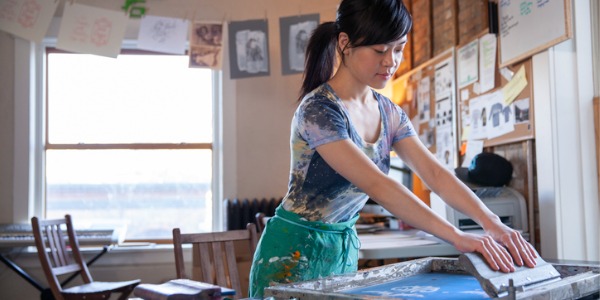 A printmaker working in her workshop.