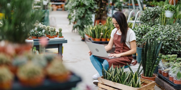 A garden center florist working on her computer.