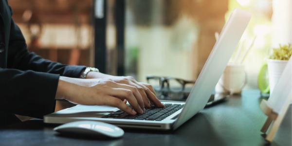 An administrative assistant working on her computer.