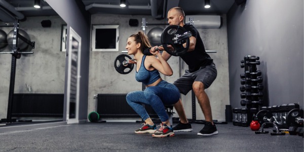 A fitness competition trainer working with a female client.