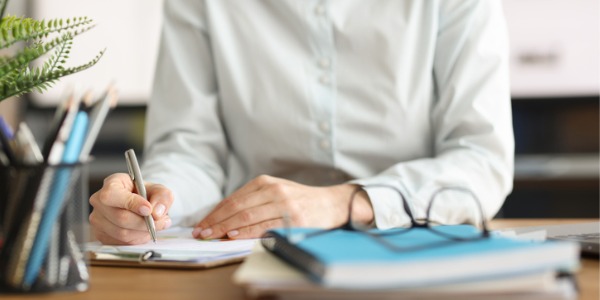 An educational administrator sitting at her desk and doing paperwork.