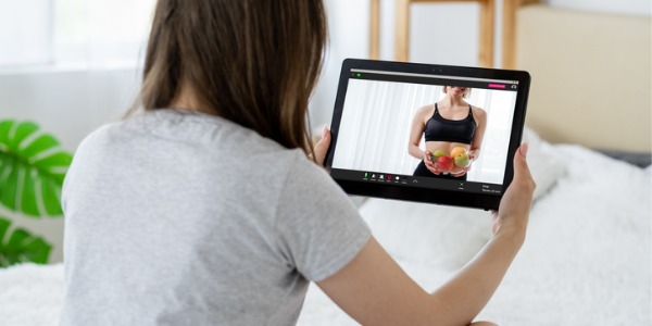 A nutrition coach talking to a client online.