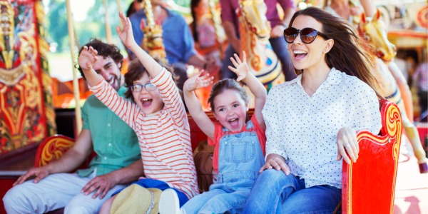 A family enjoying a ride at an amusement park.