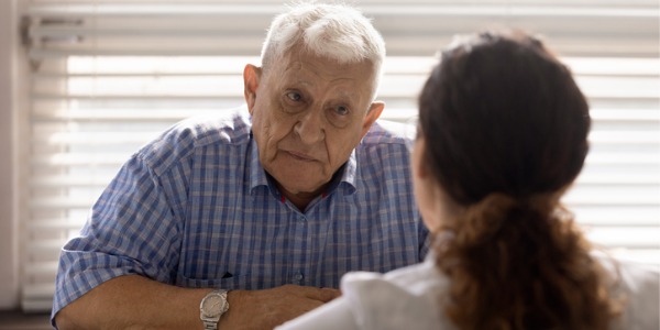 A geriatric counselor talking to a patient.