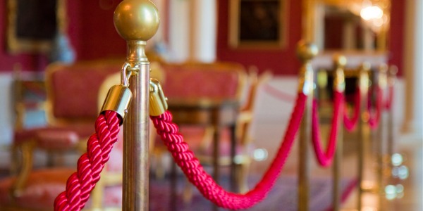 Detail of red rope on an exhibition space, designed by an exhibit designer.