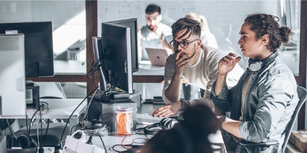 Two web accessibility developers identifying accessibility barriers on a website.