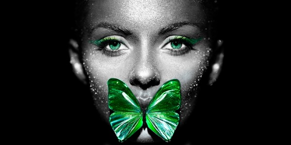 An example of fine art photography, showing a black and white photograph of a woman contrasted with a green butterfly covering her mouth.