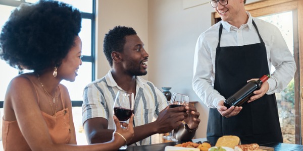 A restaurant sommelier recommending wine pairings for guests.
