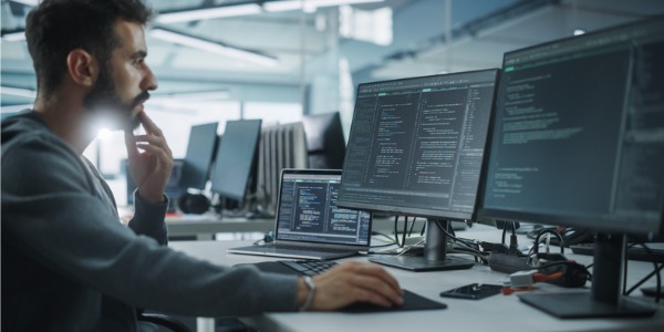 A software quality assurance engineer working on his computer.
