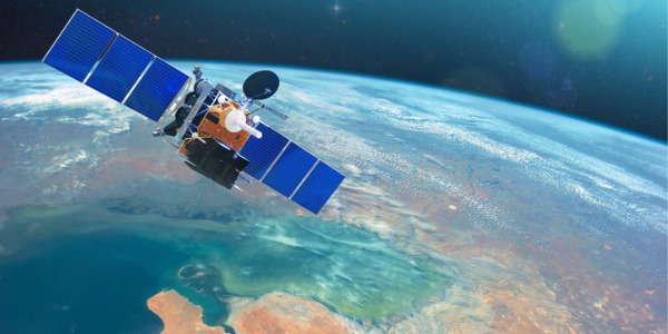 A satellite orbiting the Earth, gathering data for remote sensing technicians.