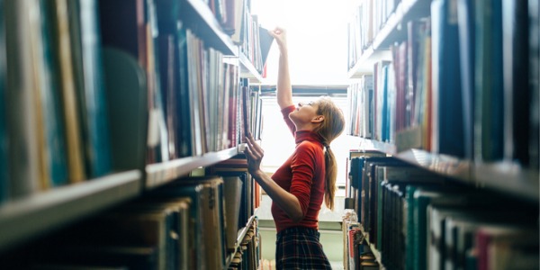A public librarian putting books away.