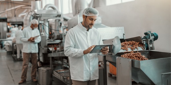 A food science technologist conducting a routine quality control test in a food manufacturing plant.