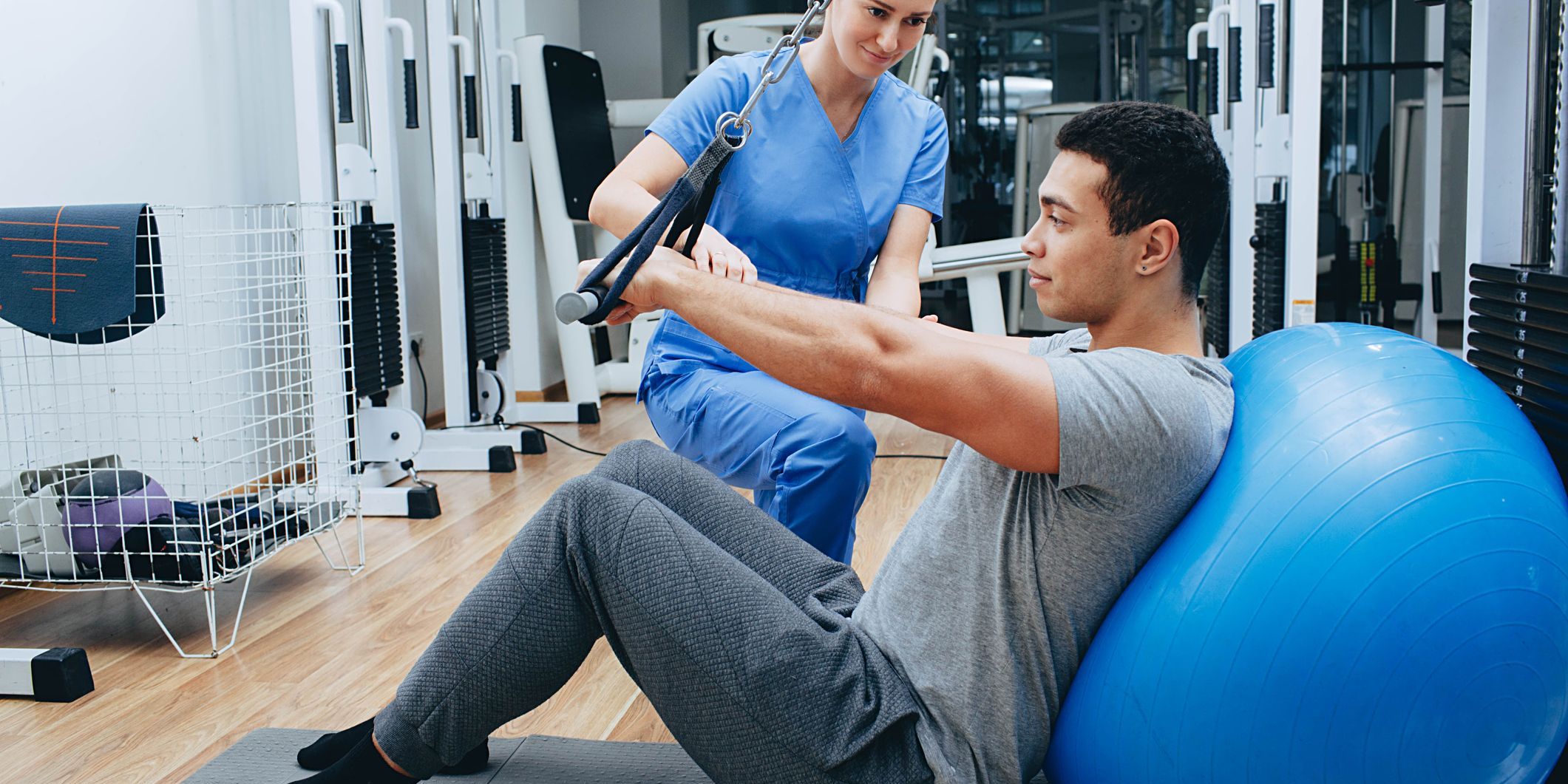 A kinesiologist working with a client.
