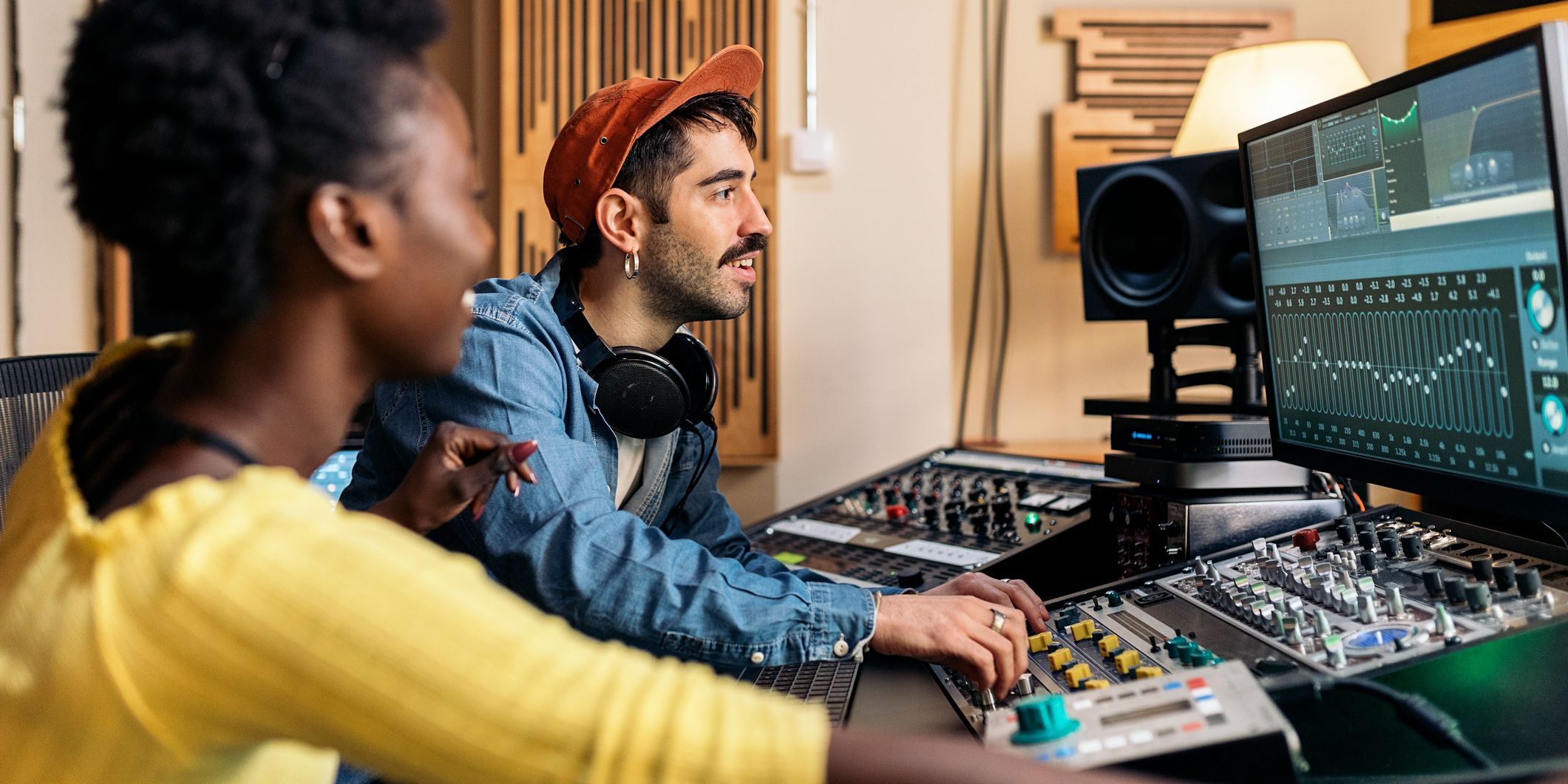 A music studio owner helping a client with his recording.
