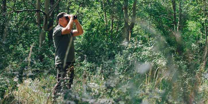 An ethologist out in the field studying wild animals.
